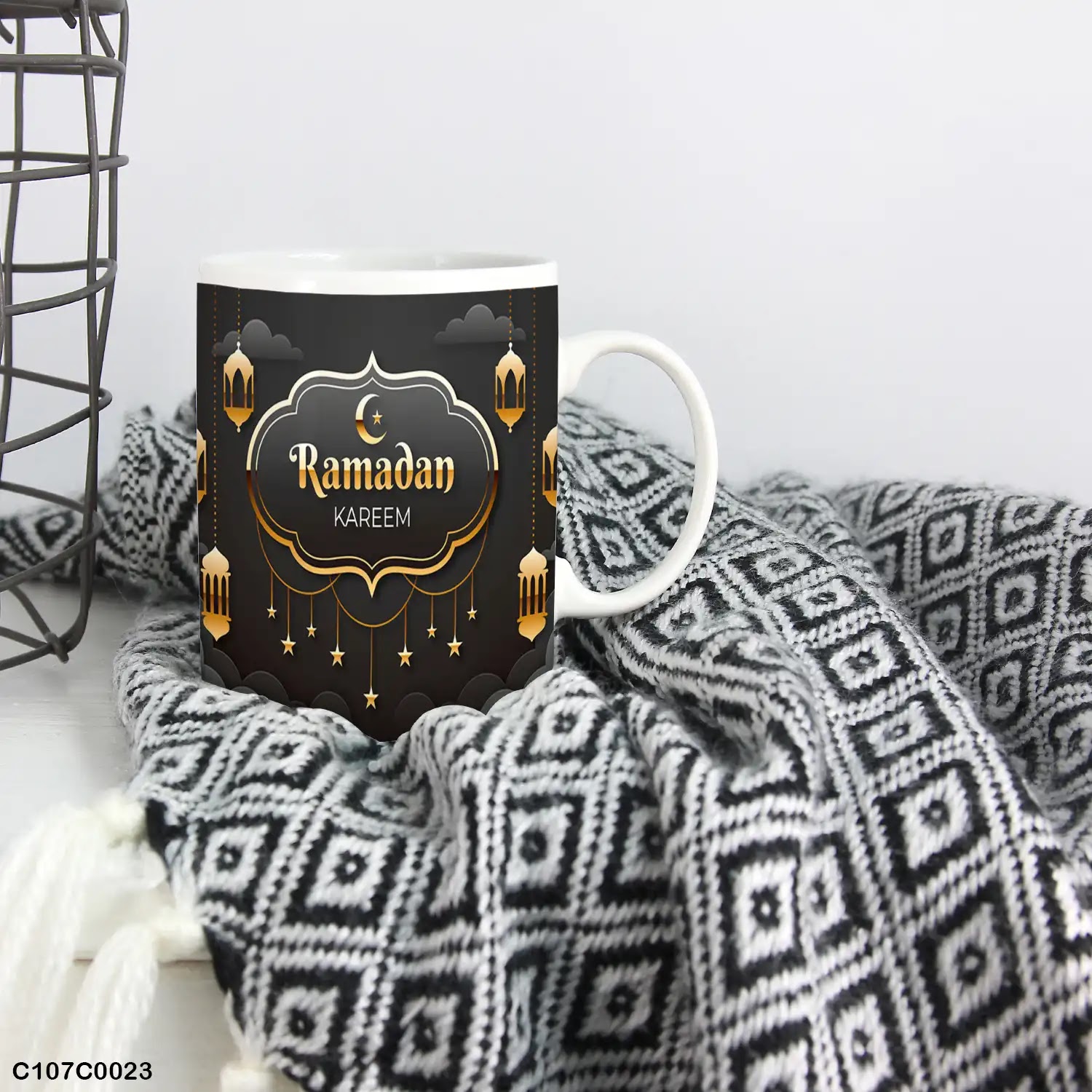A black mug (cup) printed with "Ramadan Kareem"