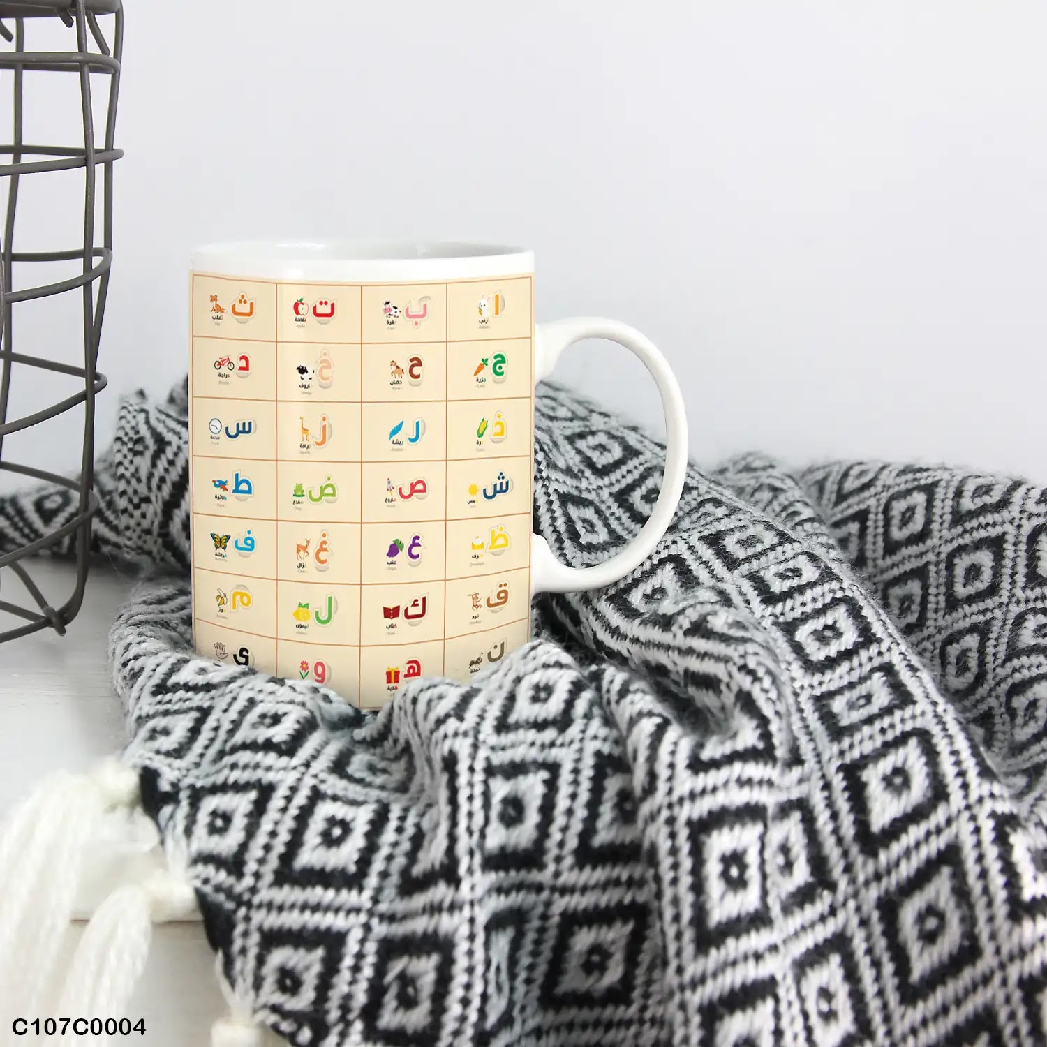 A mug (cup) printed with an Arabic alphabet