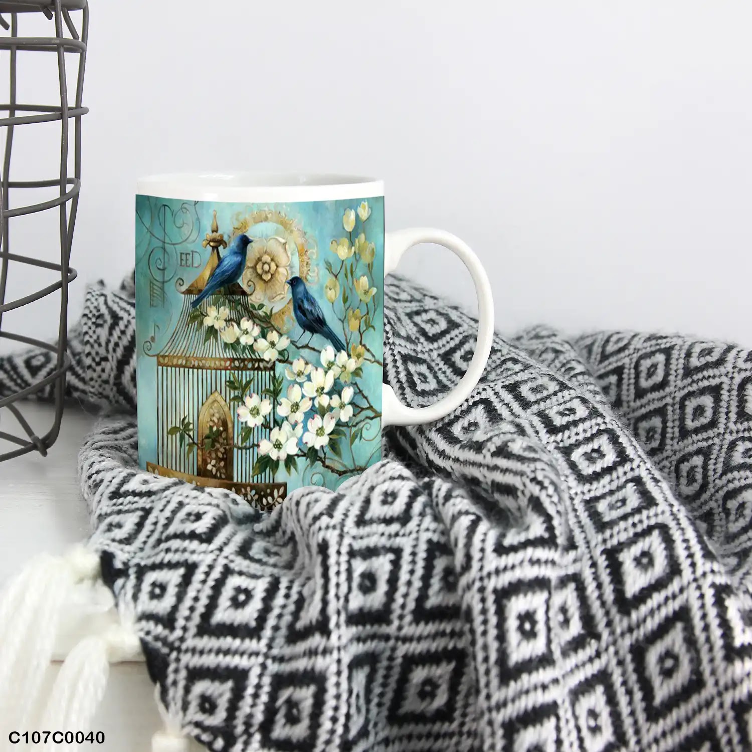 A Turquoise mug (cup) printed with an image of flowers and bird cage