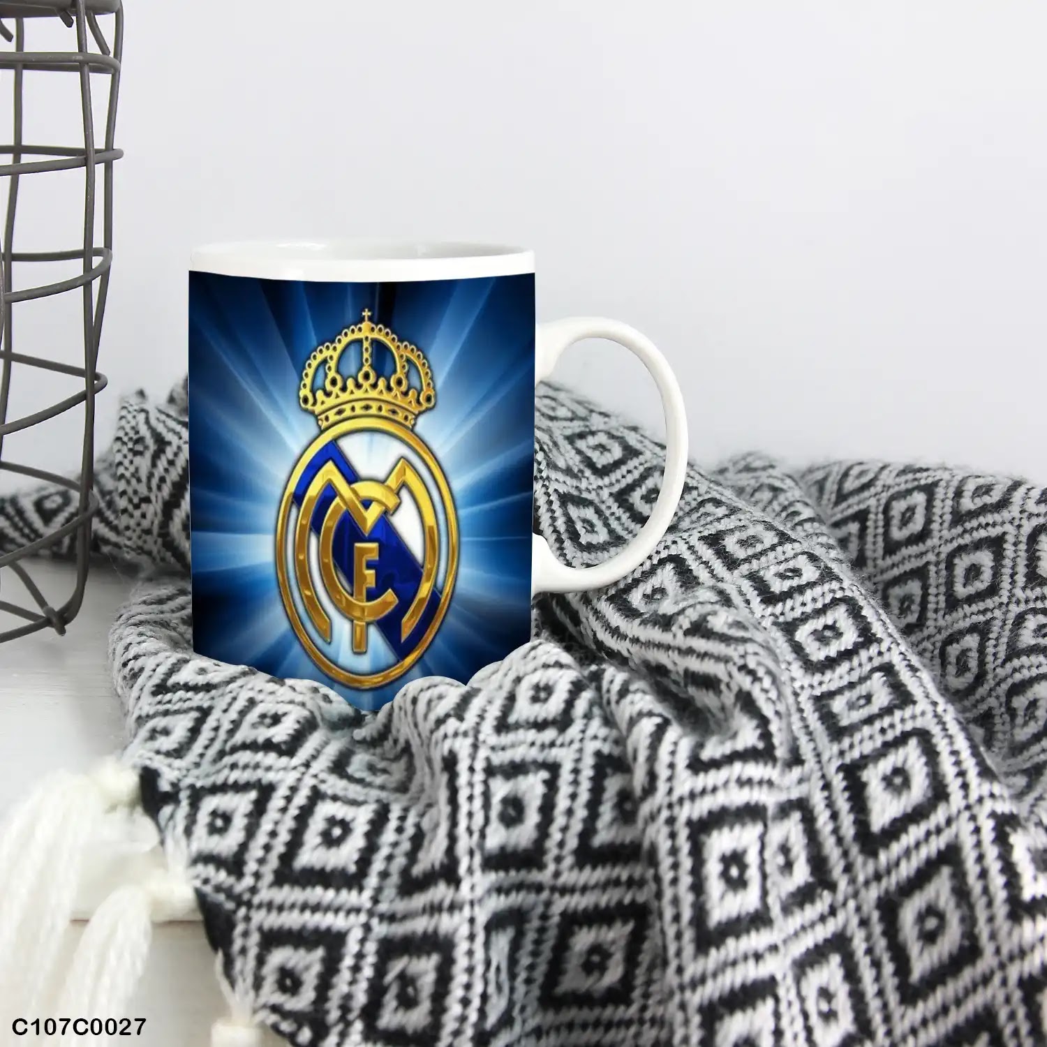 A mug (cup) printed with an image of a Real Madrid logo