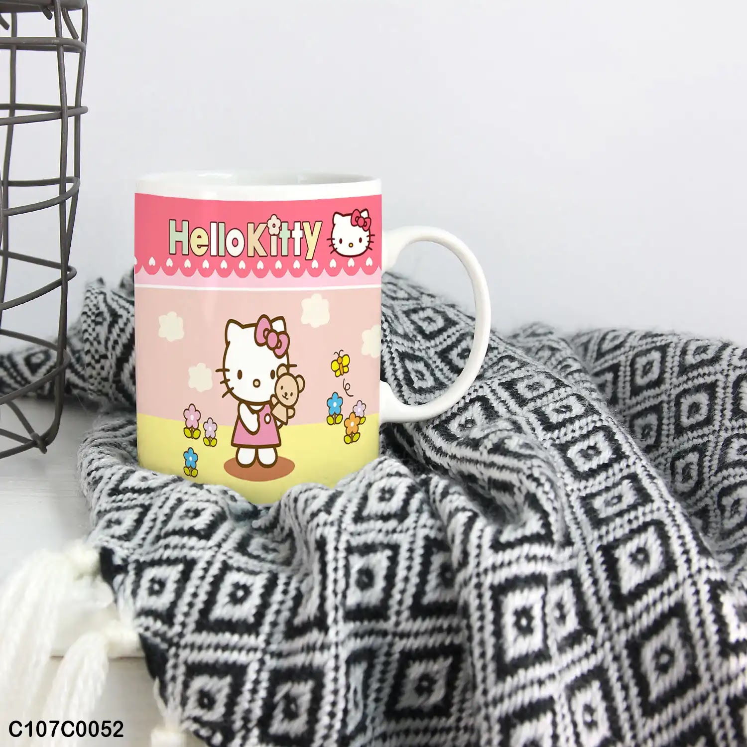 A pink mug (cup) printed with an image of "Hello Kitty" for children
