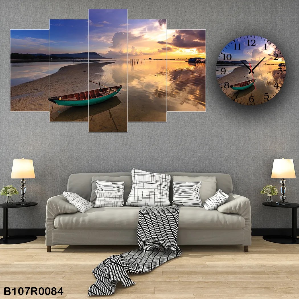 A clock and large picture of the beach and a boat