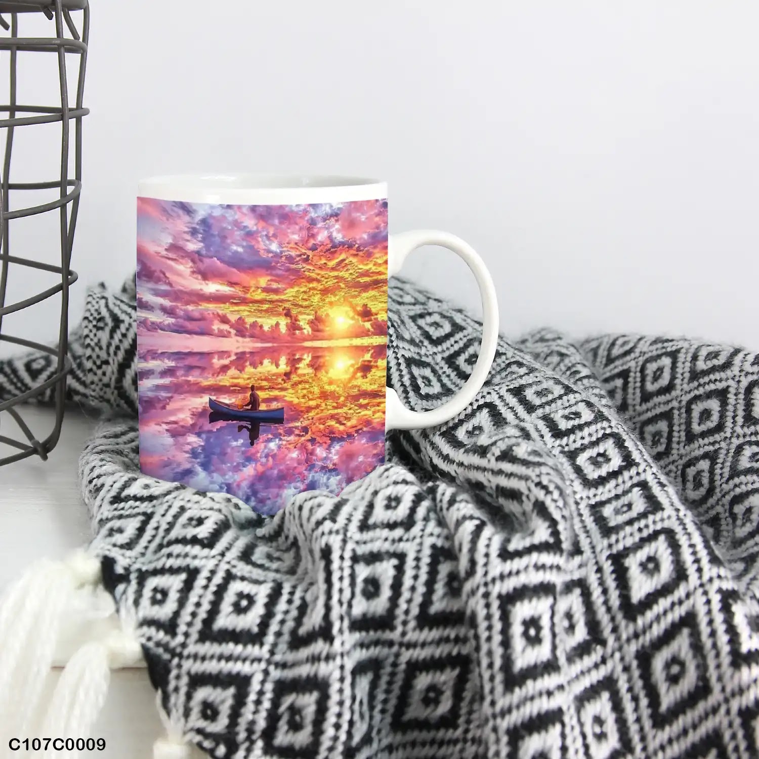 A mug (cup) printed with an image of a boat and lake at sunset