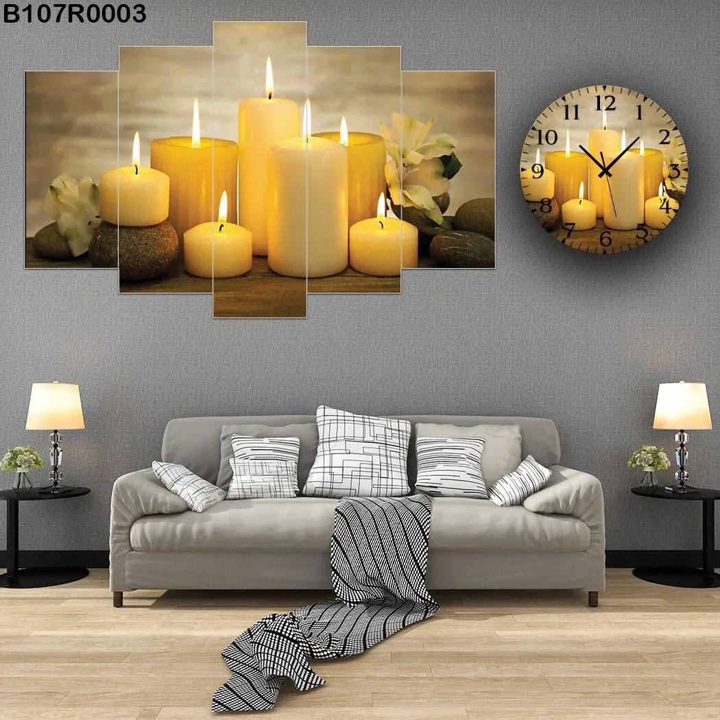 A clock and Yellow wall panel with candles