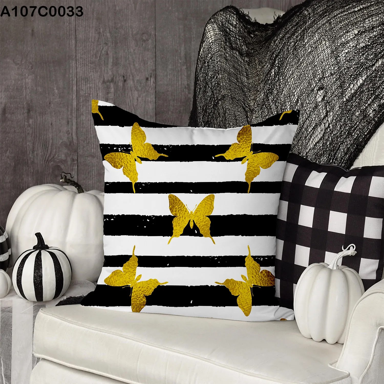 White and black striped pillow case and gold butterflies