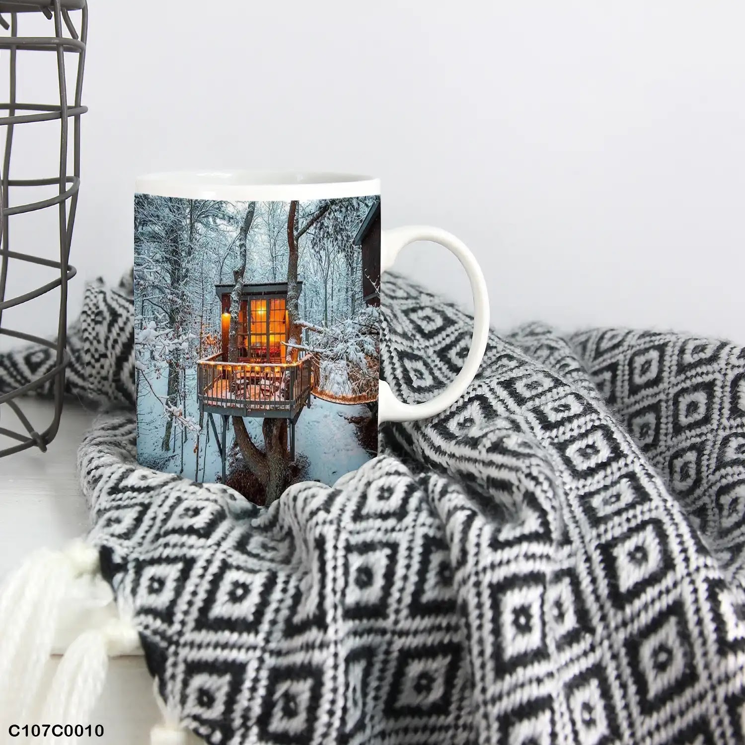 A mug (cup) printed with an image of a cottage in snowy forest