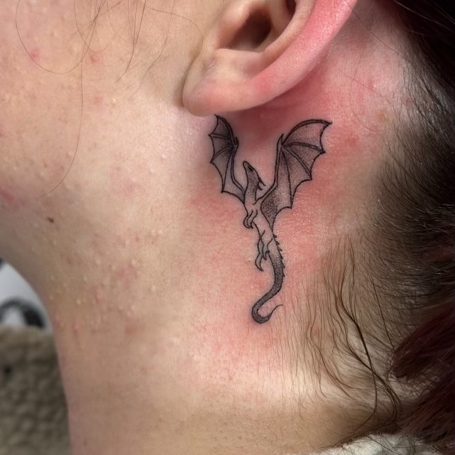 Black & Brown Bat Behind The Ear Tattoo