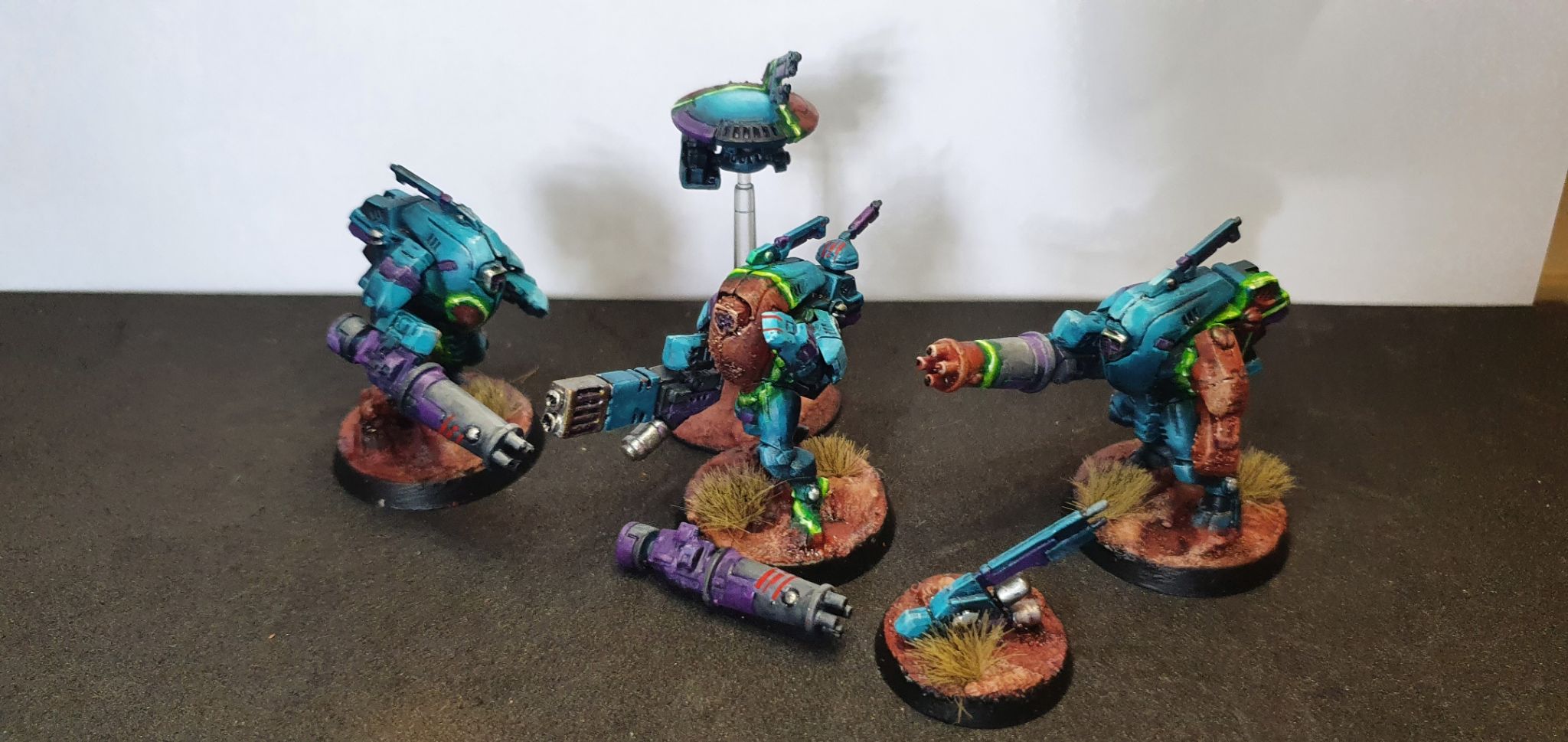 blue stealth suits, midway through transitioning to a camouflaged state