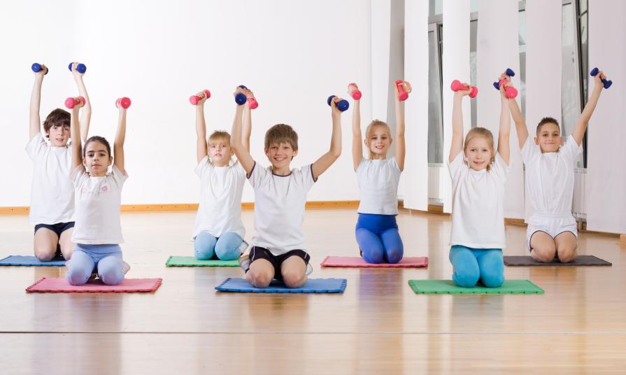 Children doing exercise with weights .