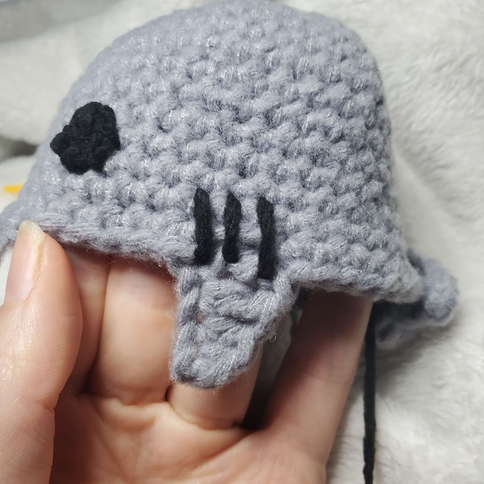 Image shows the placement of the crochet shark lovey embroidery of the gills. 