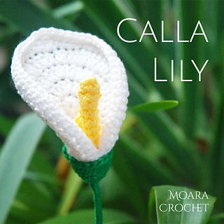 crochet calla lily in front of greenery