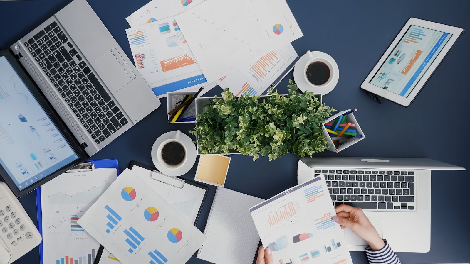 stock image of laptops and papers on a desk