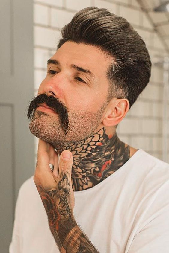 man with neck tattoo spotting mustache