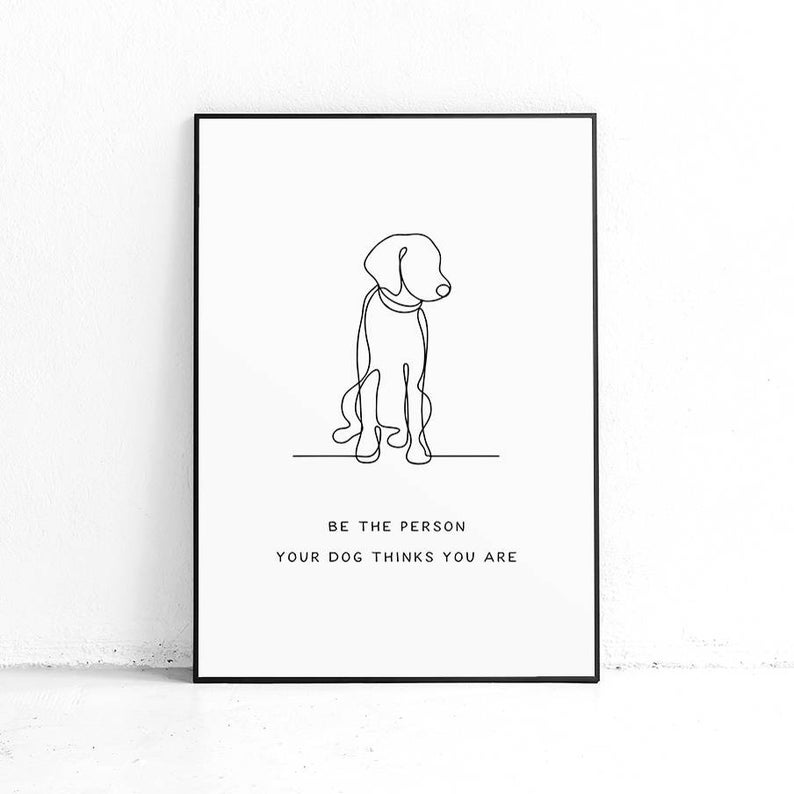 Framed black and white print of a line drawing of a dog with the text "Be the person your dog thinks you are" below.