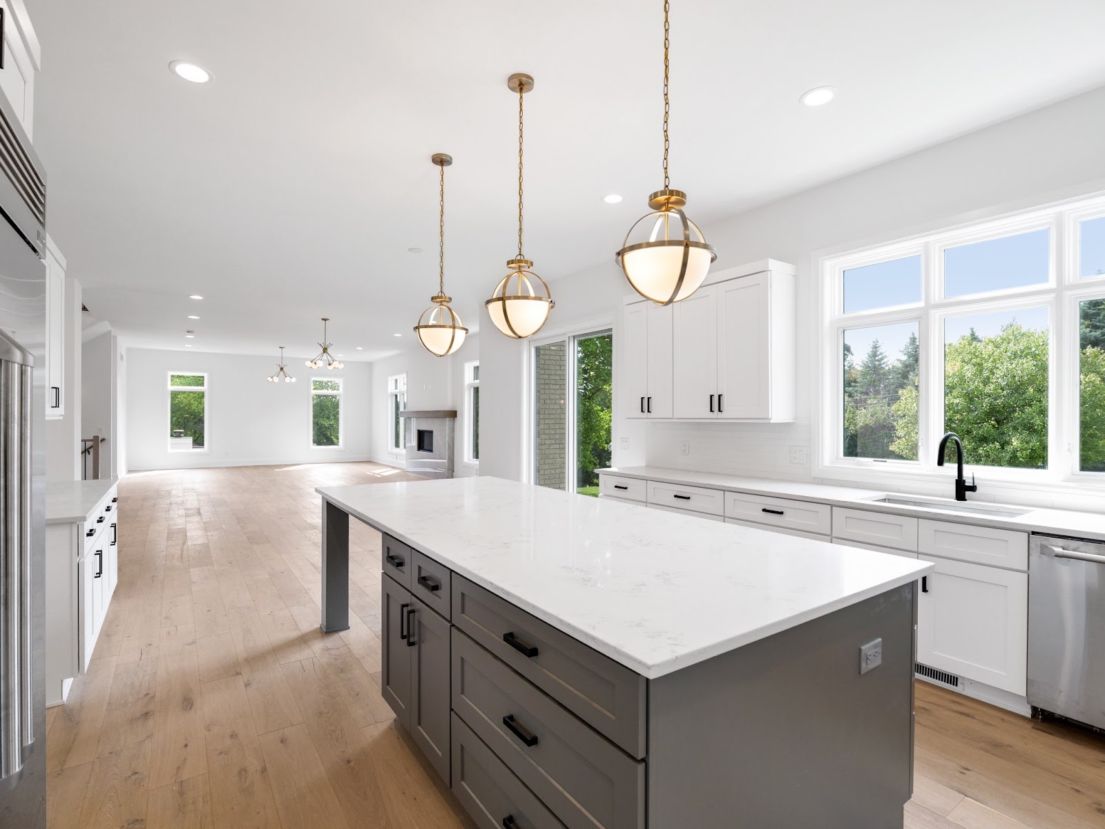 large kitchen with white shaker cabinets and grey shaker cabinets on the island, as well as white countertops. grey shaker cabinets are one of the best kitchen trends for 2020