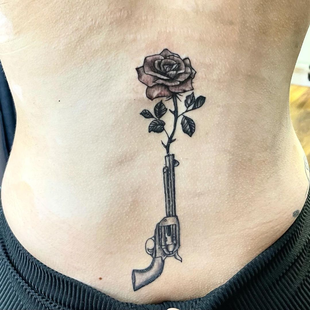 Rose And Gun Tattoo On Back Waist