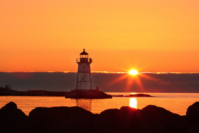 Grand Marais lighthouse at sunrise by Glenda Mueller
