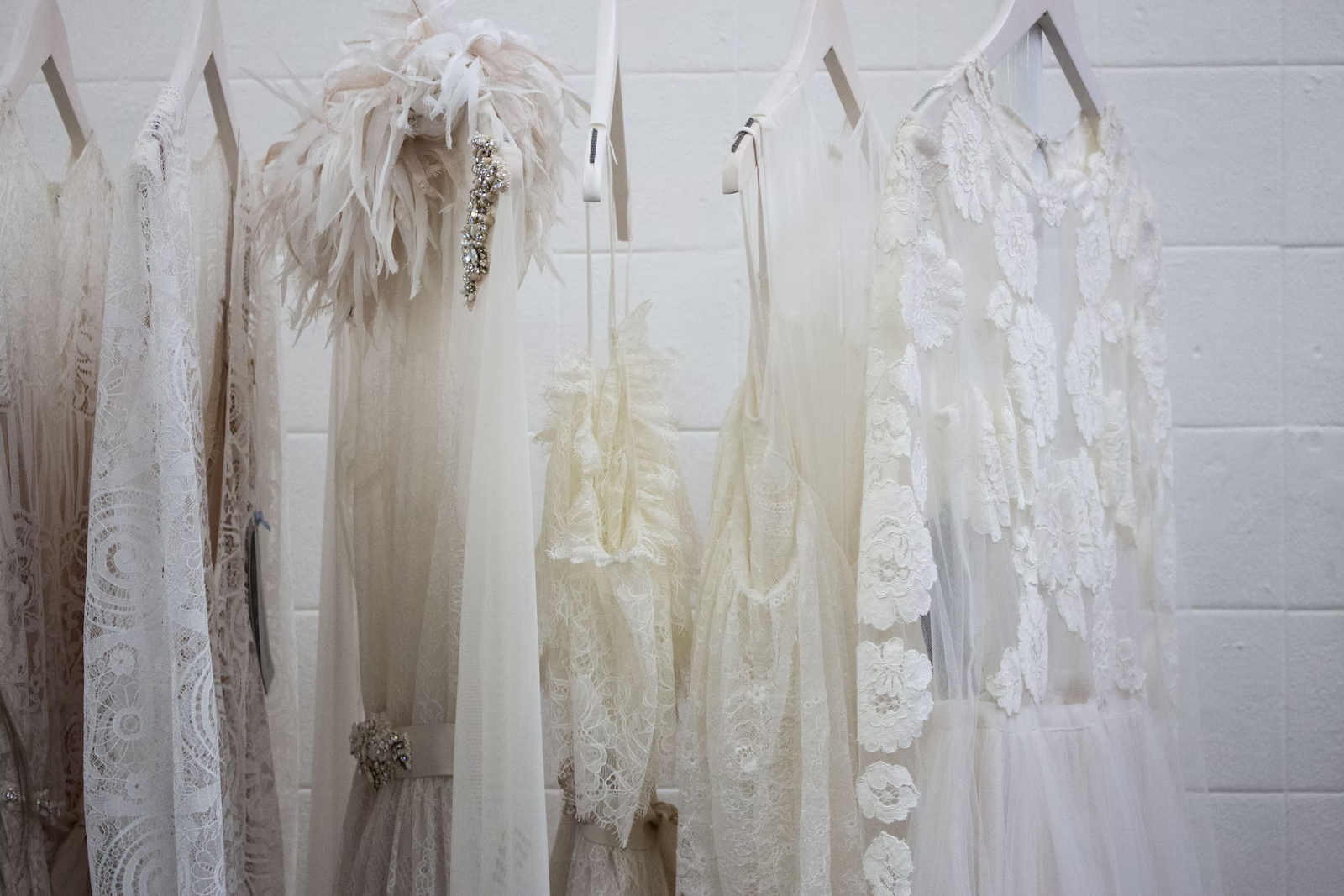 White wedding dresses hanging on hangers