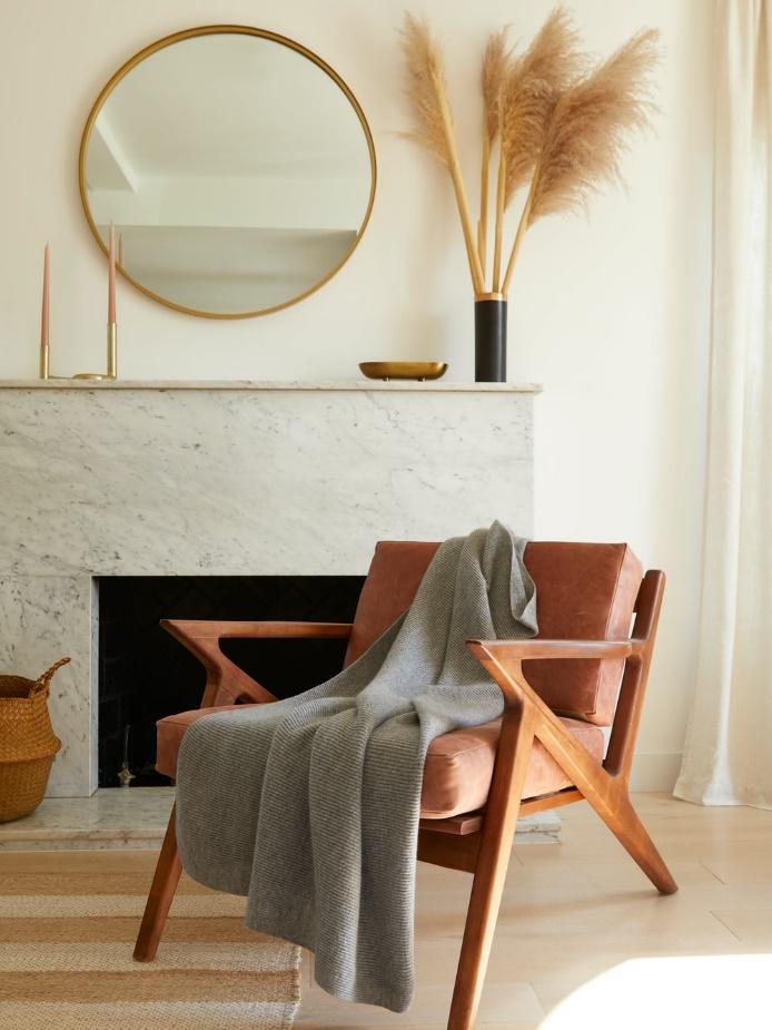 brown wooden chair beside gray textile