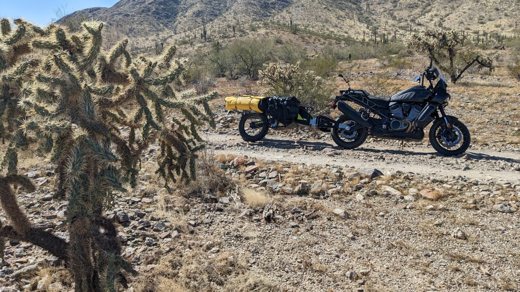 The Pasq ADV1 one-wheeled motorcycle trailer in the Arizona desert, being pulled by a Harley Davidson Pan America