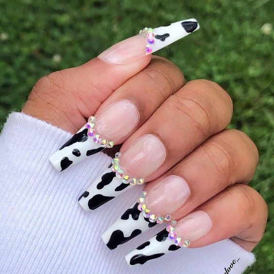 Close up view of the cow print nails with beads