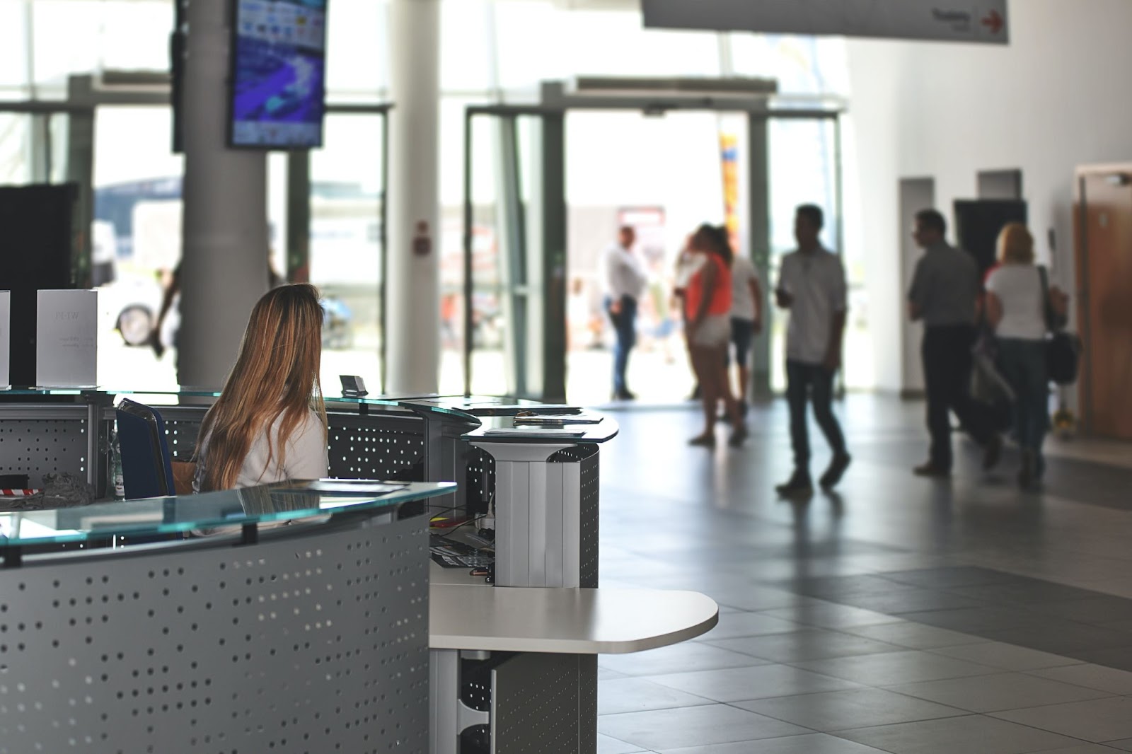Airport Assistance Hub, A woman sitting on Airport Reception, Airport Assistance services, Meet and greet