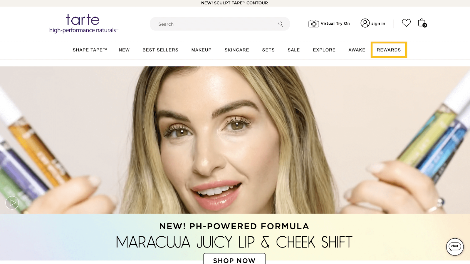 Rewards Case Study tarte perks–A screenshot of tarte’s homepage showing a blonde woman holding several of their Maracuja Juicy Lip and Cheek Shift products. The ‘Rewards’ section in their menu is outlined in a yellow box. 