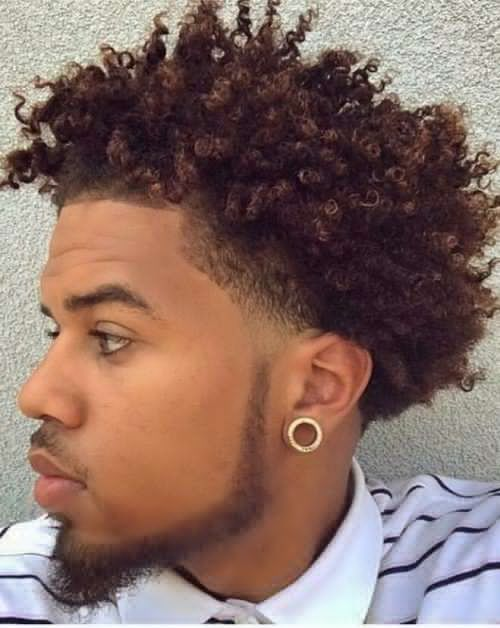 a man rocking a curly male hairstyle