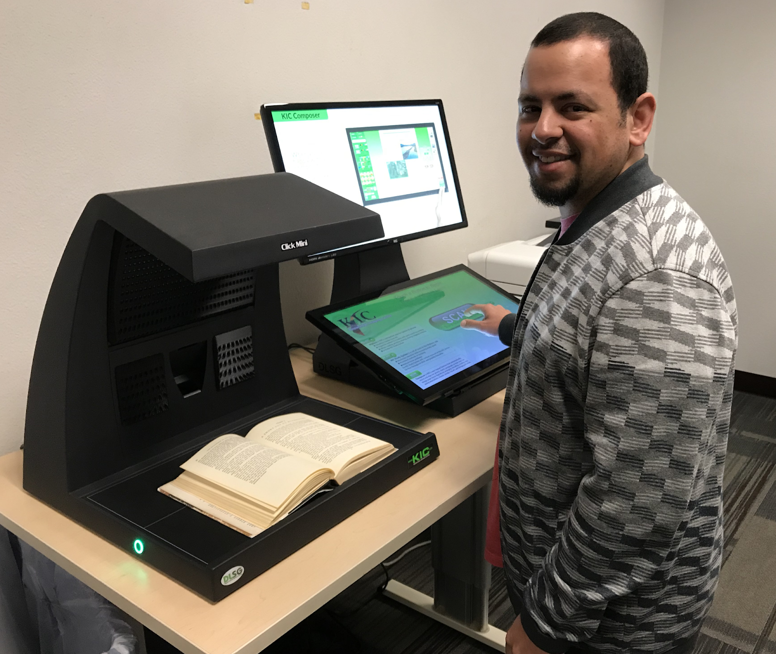 Student using scanner to scan a book in the library