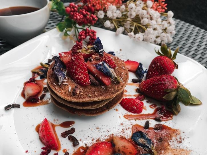 three pancakes topped with berries