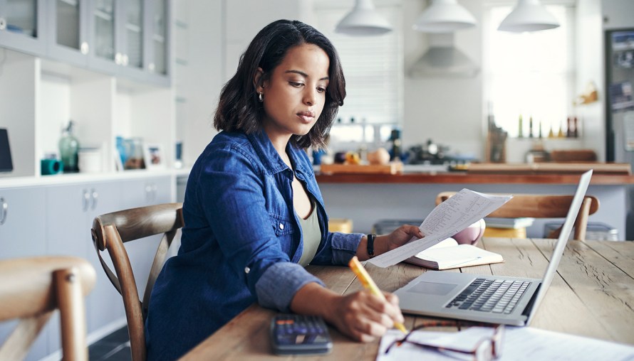 woman at kitchen table doing work