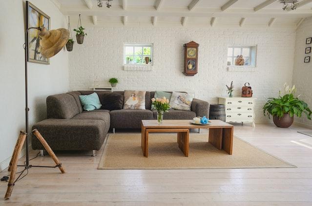 Living room with a large gray corner sofa and a wooden coffee table in front of it
