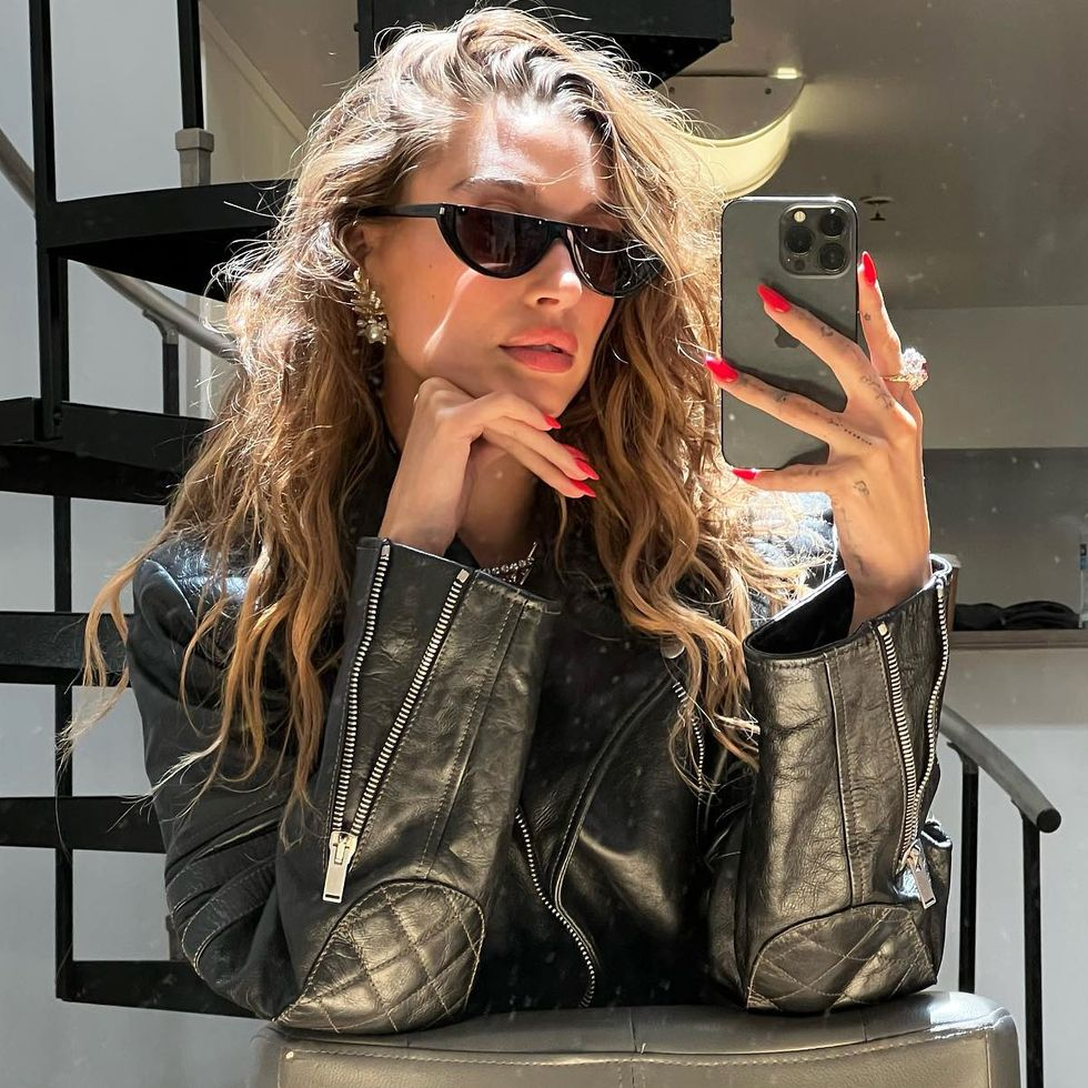Hailey Bieber Nails: Hailey takes a selfie showing off her red fiery nails 