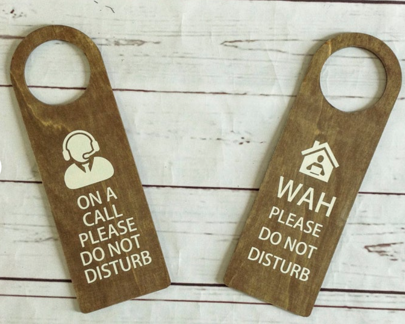 door status paddle with printed messages on wood background