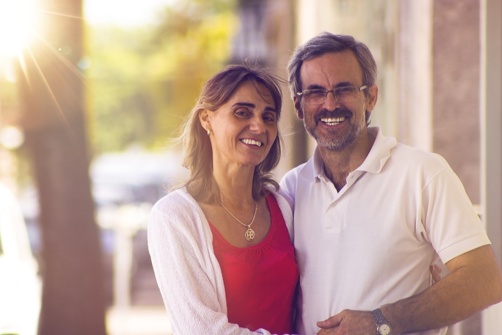 Pre-retirement aged couple smiling outside