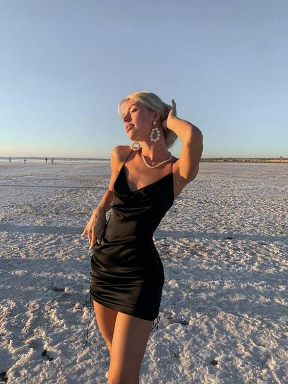 lady wearing little black dress at the beach