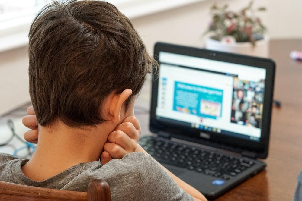 boy with ADHD learning online with laptop
