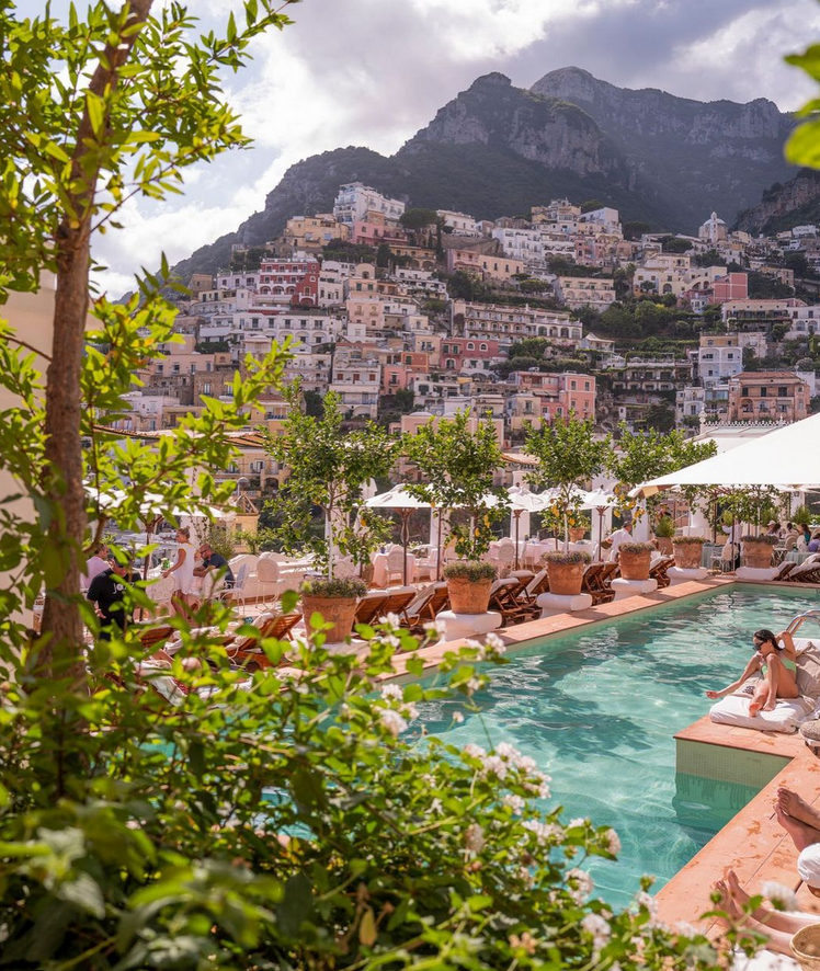 A view of the pool at Le Sirenuse luxury hotel overlooking the city of Positano on the Amalfi coast.