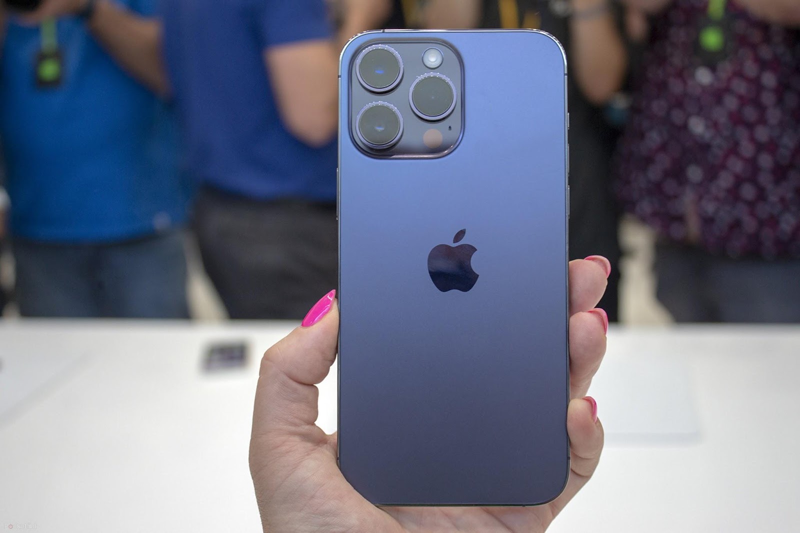 This image shows the iPhone 14 Pro Max in the hands of a woman.