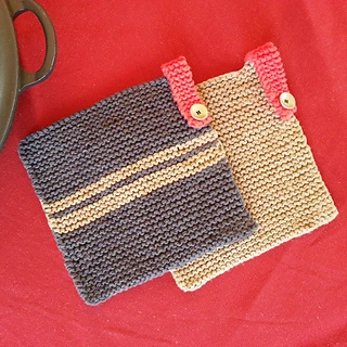 two potholders with knitted hanging loops on red background