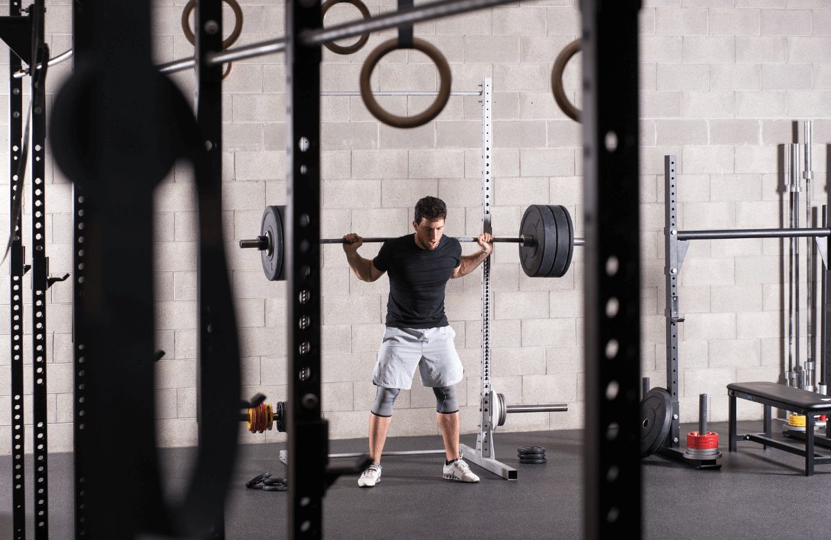 An athlete using a squat rack