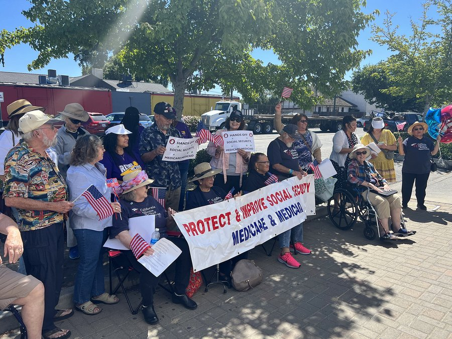 Seniors gather with signs calling to protect and improve Social Security, Medicare and Medicaid