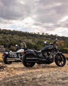 Explore the beauty of nature with a pair of Indian motorcycles parked on a scenic field