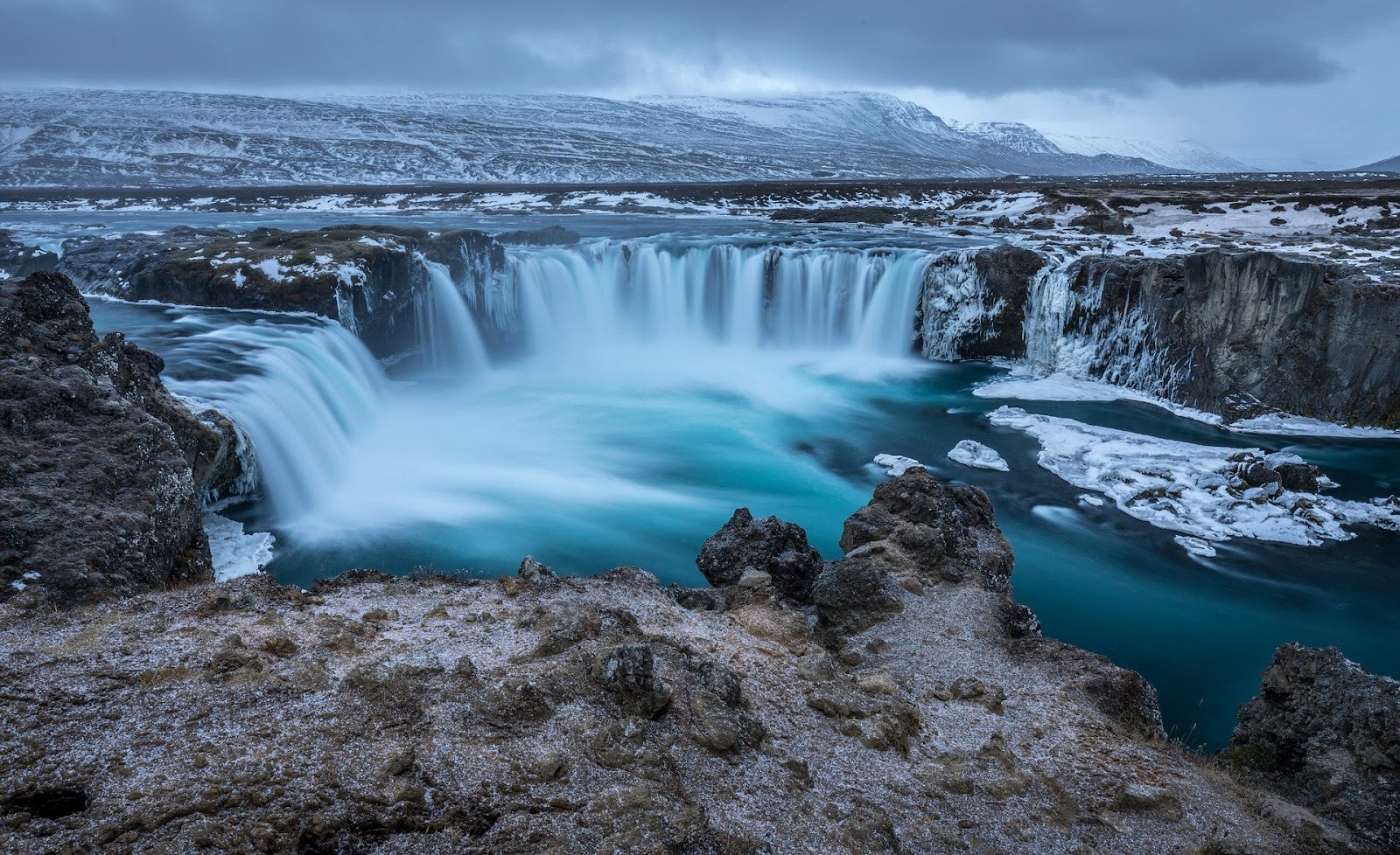 godafoss wide short waterfall ice and snow covered in winter iceland