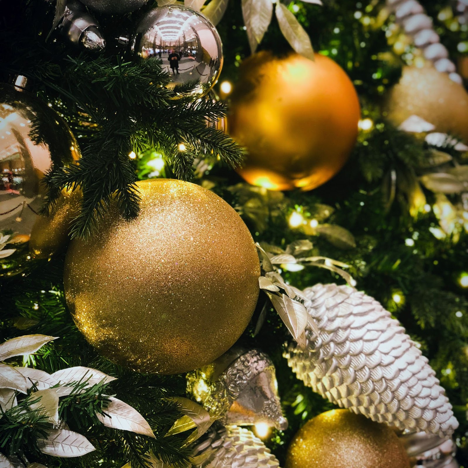 silver and gold Christmas ornaments on a Christmas tree