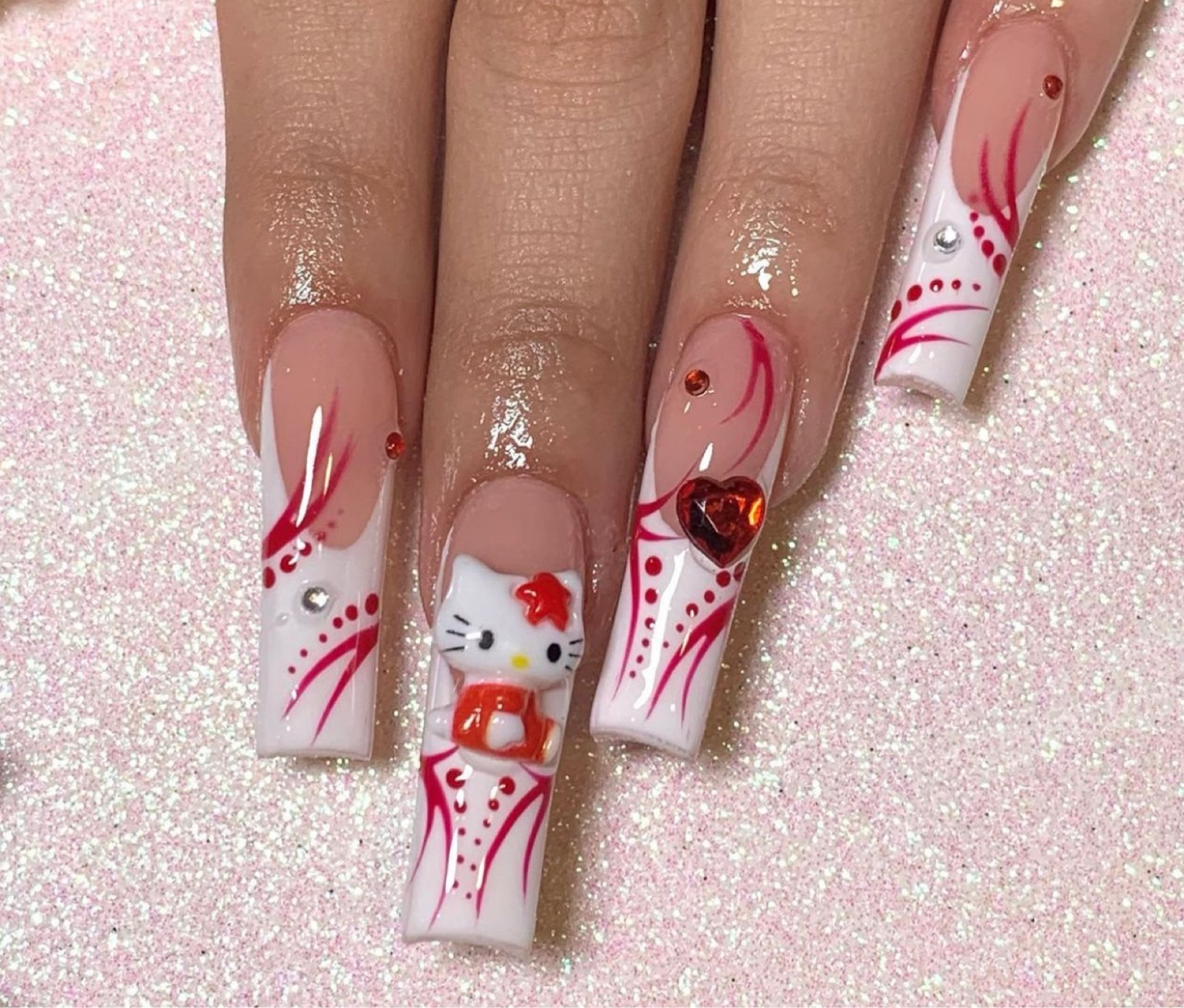 Hello Kitty nail art design with red details on long nails