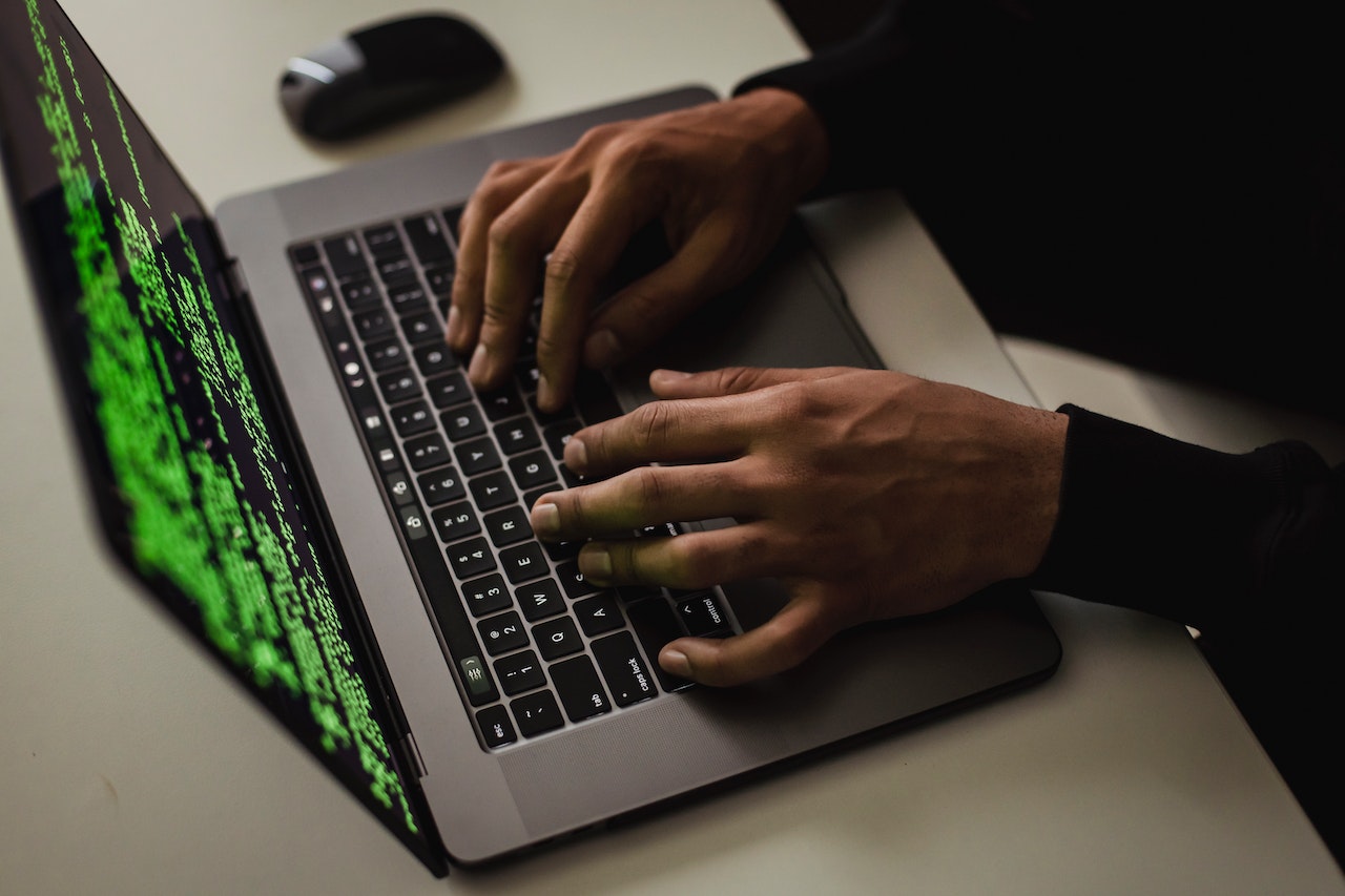 https://www.pexels.com/photo/crop-cyber-spy-hacking-system-while-typing-on-laptop-5935794/