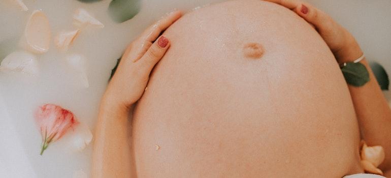 a pregnant woman's stomach in a relaxing bath