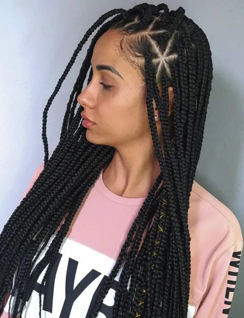 Side view of lady showing off the triangle parted small box braids