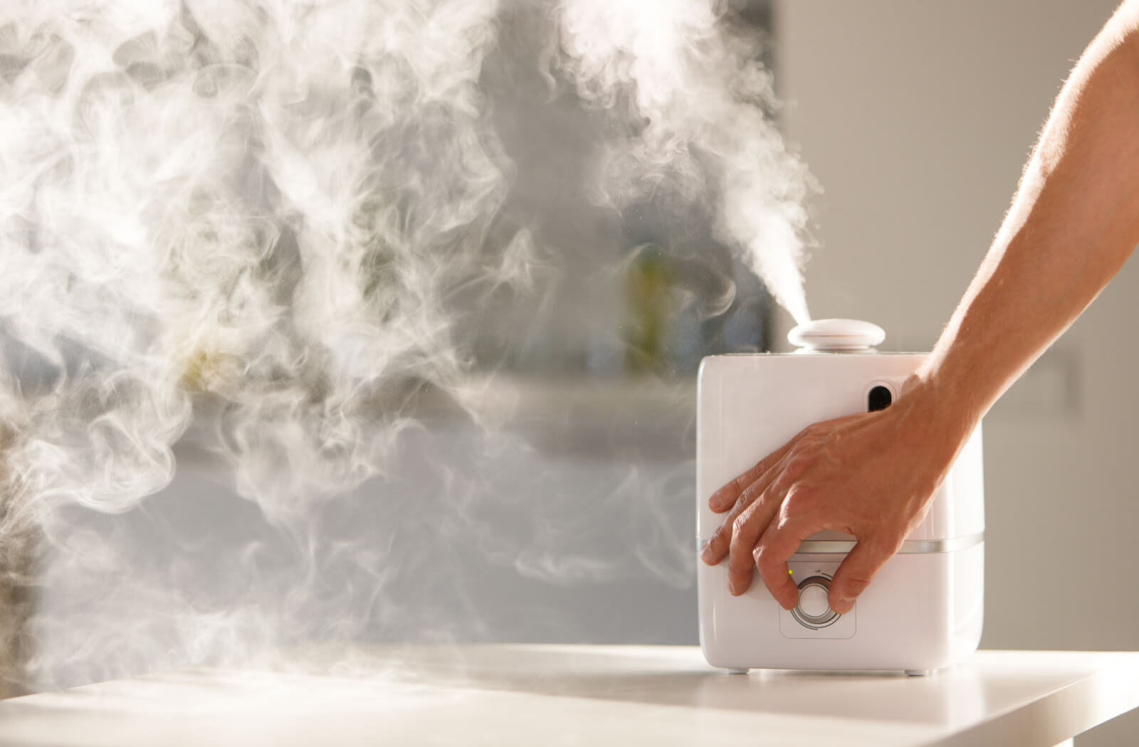 a hand reaches into the screen turns up a setting on a humidifier to attempt dry eye relief